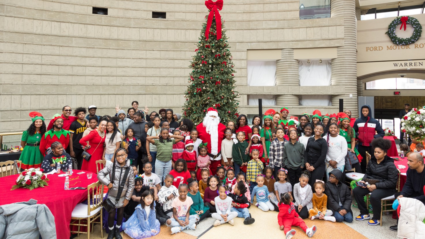 Santa, elves and children gathered for a group photo in the atrium
