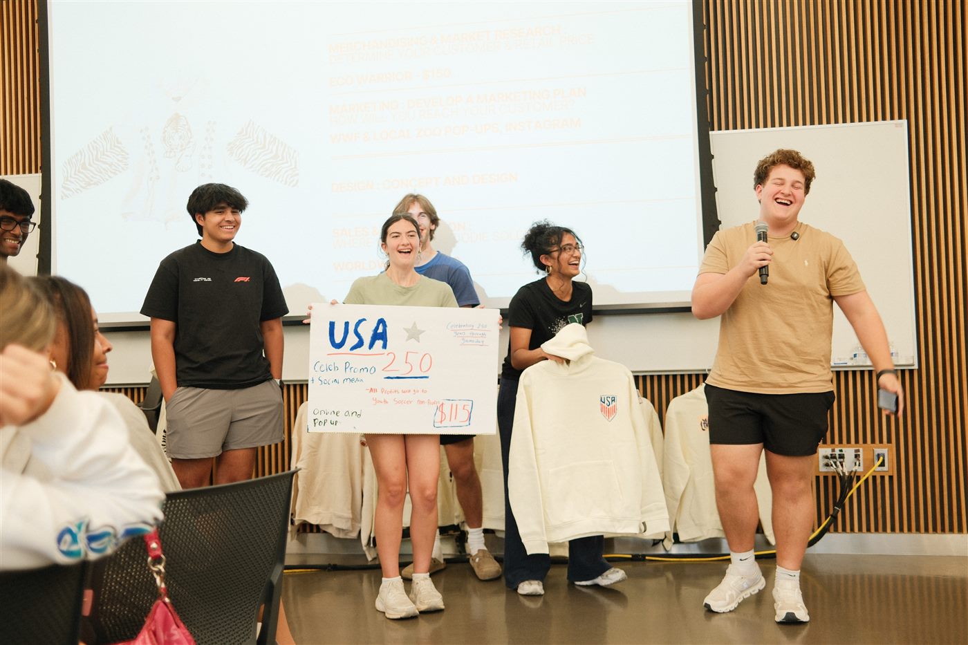 Students on stage holding a camp award at MSU